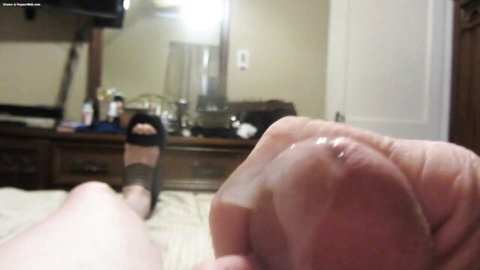 Seanette Carey jerks her cock while dressed in striped sandals