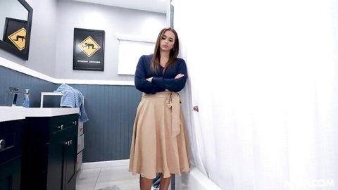 Armani Black in navy sweater and beige skirt, arms crossed seductive pose