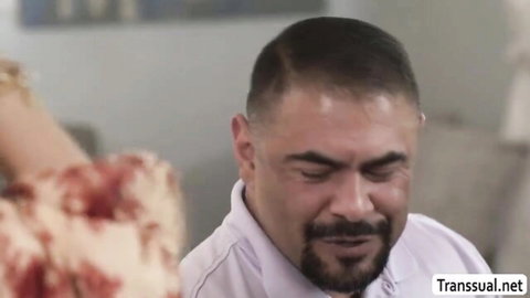 Bearded Latino man tears up eating pizza with woman's hand on shoulder
