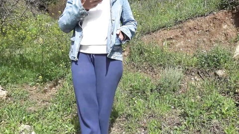 Souzan Halabi in casual outdoor pose, denim jacket, white top, blue pants