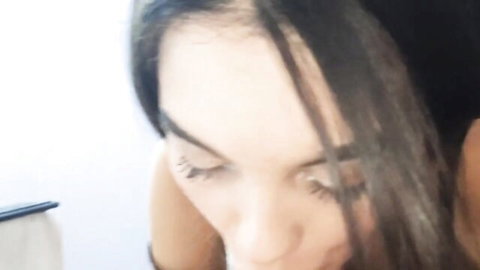 Closeup of brunette babe's ecstatic face with open mouth and rolling eyes during intense blowjob