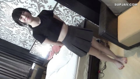 Petite Asian teen with tiny tits in crop top and pleated skirt posing barefoot