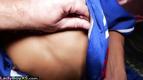 Petite Asian ladyboy's shorts pulled down by man's hand, teasing big ass