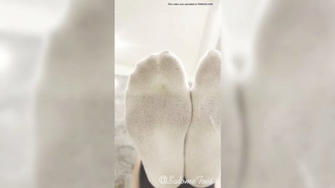 Asian socks POV close-up of women's feet soles in white stockings