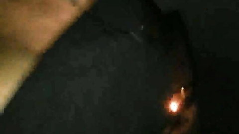 Dark silhouette of Italian solo babe fingering flame in car at night