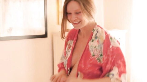 Amy Ferguson nude tits exposed in open red kimono, smiling seductively