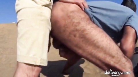 Man bent over exposed hairy ass for outdoor bareback sex on dune with stranger