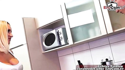 Skinny blonde MILF in revealing orange top teasing in kitchen