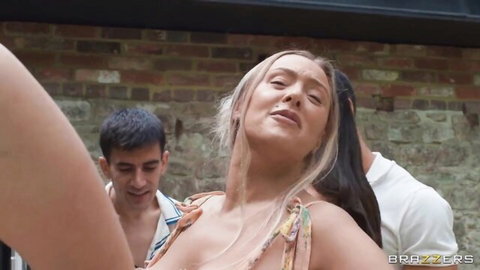 Blonde babe with huge tits arches back in ecstasy sandwiched by two studs in outdoor threesome.