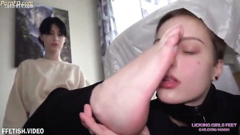 Two Asian women in foot licking fetish, slave worshiping mistress's bare feet