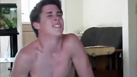 Shirtless young Caucasian man moaning in ecstasy during home sex