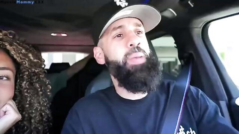 Curly-haired ebony babe flirts with bearded stud in car
