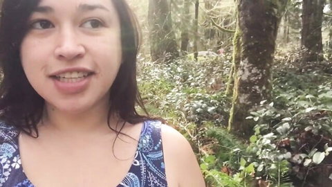 Kezia Slater smiles in blue floral dress amid forest, amateur outdoor tease