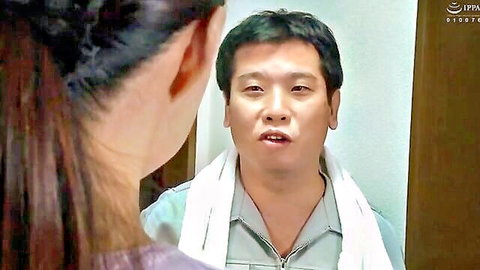 East Asian woman faces shirtless man with towel around neck in intimate close-up talk