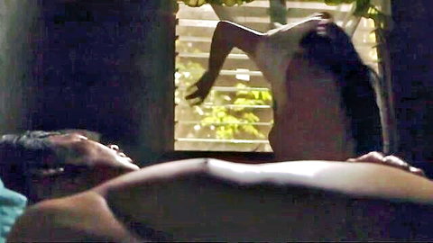 Nathalie Hart in intimate bedroom scene, bending near window with lover