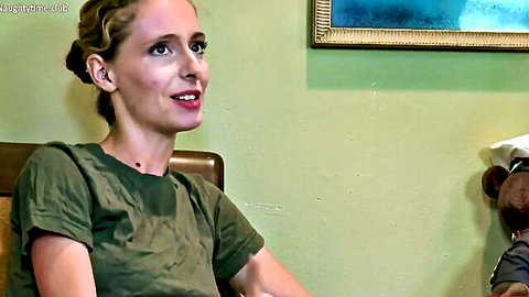 Blonde woman in green t-shirt smiling with teddy bear, surprise ending tease