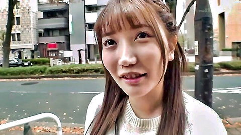 Young Asian woman with long brown hair smiling in white turtleneck sweater outdoors, JAV preview