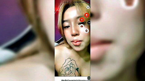 Indonesian amateur babe with rose tattoo on cleavage pouts plump lips teasingly