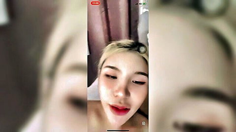Topless blonde Thai woman in amateur live stream tease