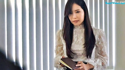 Yuko Ono in elegant white lace blouse, long hair, holding notebook