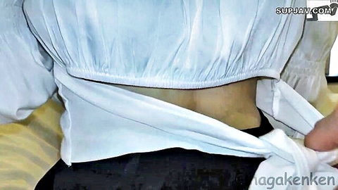 Asian woman in white blouse undressed from behind by hands