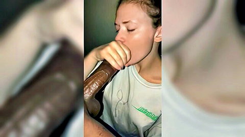 Pale redhead sucking massive BBC dildo passionately