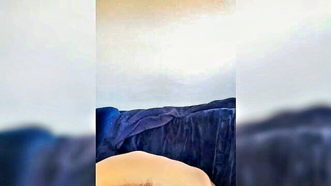 Nude woman lying on stomach, bare ass visible in close-up adult scene