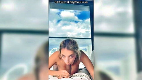 Blonde with big tits and ass sucks cock POV on bed by window