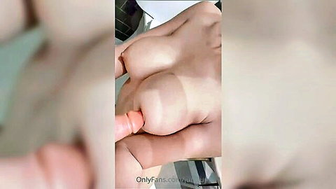 Busty pale woman masturbating with pink dildo insertion close-up
