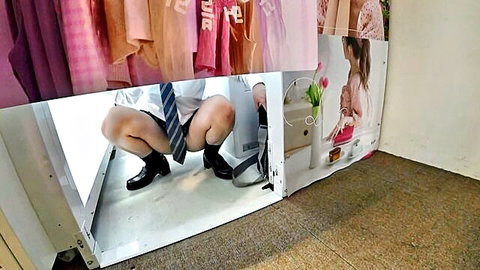 Schoolboy squats in changing booth with shorts down exposing bare ass and hanging cock