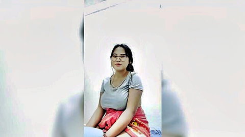 Indonesian woman with big boobs in gray tank top and red skirt, viral live stream