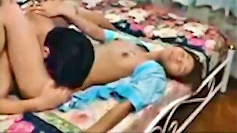Asian man fucks mature Thai woman's exposed tits pussy missionary on bed