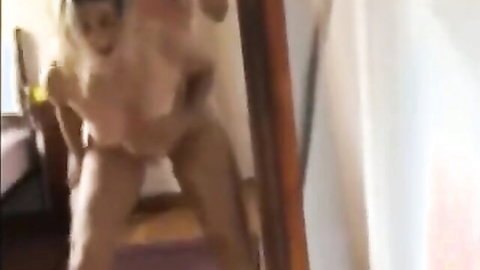 Mature MILF bent over getting anal fucked doggy style by man in bedroom mirror.