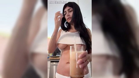 Mia Khalifa in revealing white crop top sipping morning drink