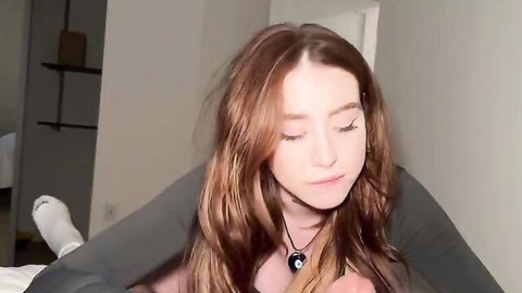 Rosie Rider redhead in cozy sweater and socks, teasing POV gaze