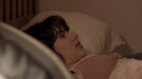 Scarlett Johansson in sheer lingerie lying seductively on bed, Under the Skin 2013 scene