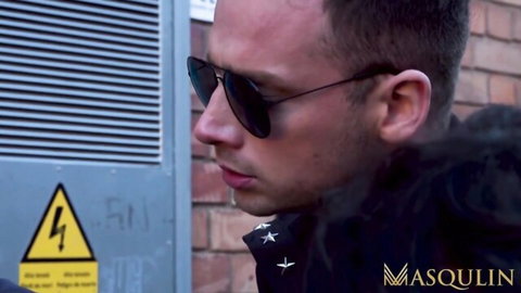 Ethan Chase in sunglasses and jacket, smoking outdoors in MASQULIN cop scene