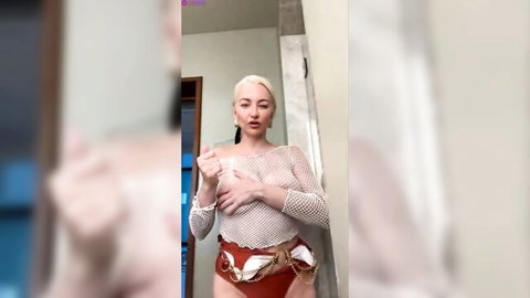 Blonde webcam girl squeezes huge natural tits through sheer mesh top and red harness panties