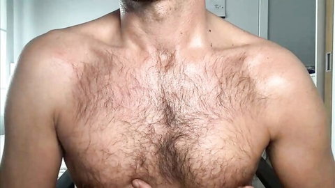 Hairy muscular Mexican gay otter showing shirtless chest and arms