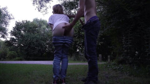 Amateur blonde exposes ass outdoors for handjob and doggy tease