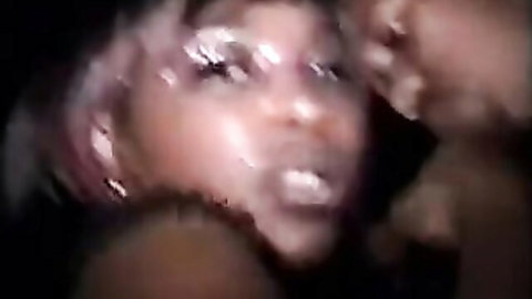 Intense close-up of ebony stripper with pink hair and glittery makeup