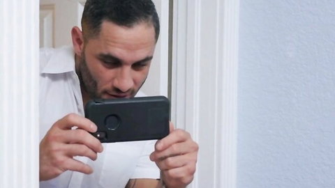 Damon in white shirt taking selfie before hot threesome
