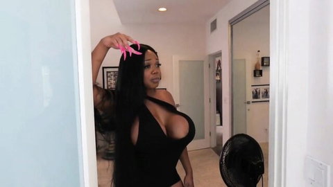 Curvy ebony babe with huge tits spilling from skimpy black cutout dress posing seductively