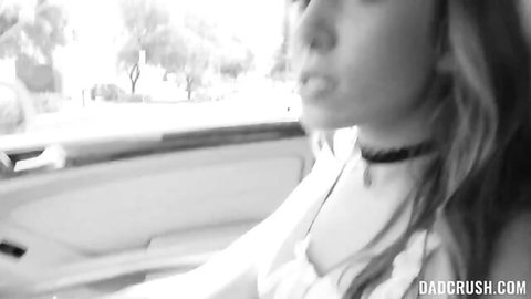 Blonde teen with choker necklace smirks seductively from car window on DadCrush