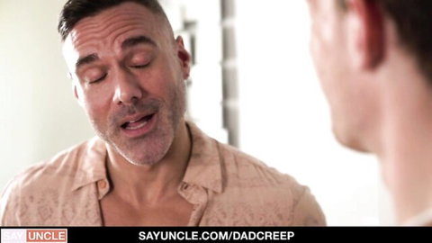 Step-dad gazing intensely at step-son in bathroom mirror during intimate moment
