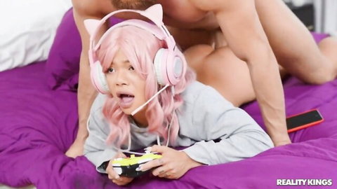 Pink-haired gamer girl in headset gets fucked doggy style while playing video games