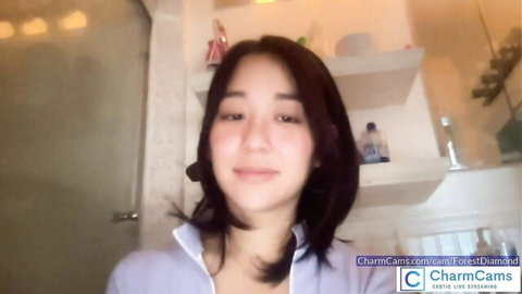 Cute Asian webcam girl in purple collared shirt smiling on Chaturbate live cam