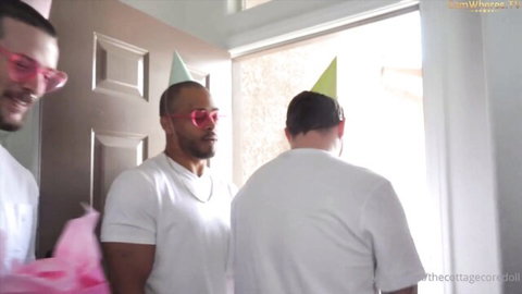 Three men in party hats and white shirts ready for CC Doll's birthday blowbang