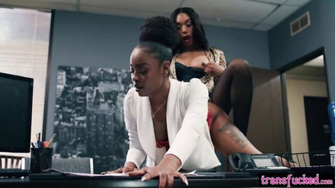 Ebony babe bent over desk enjoyed by shemale in lingerie
