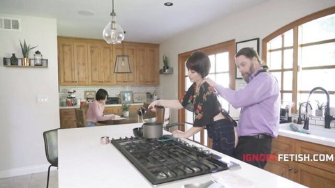 MILF mom in tight pants stirs pot on stove groped by husband from behind with daughter at table